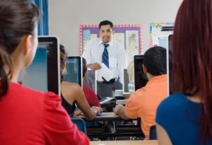 Students with teacher in classroom, technical support